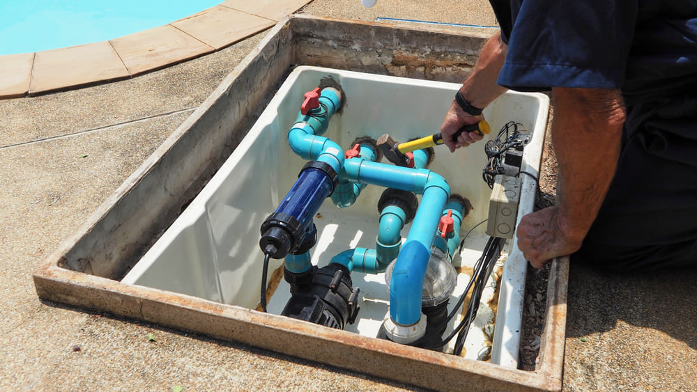 technician repairing a pool pump